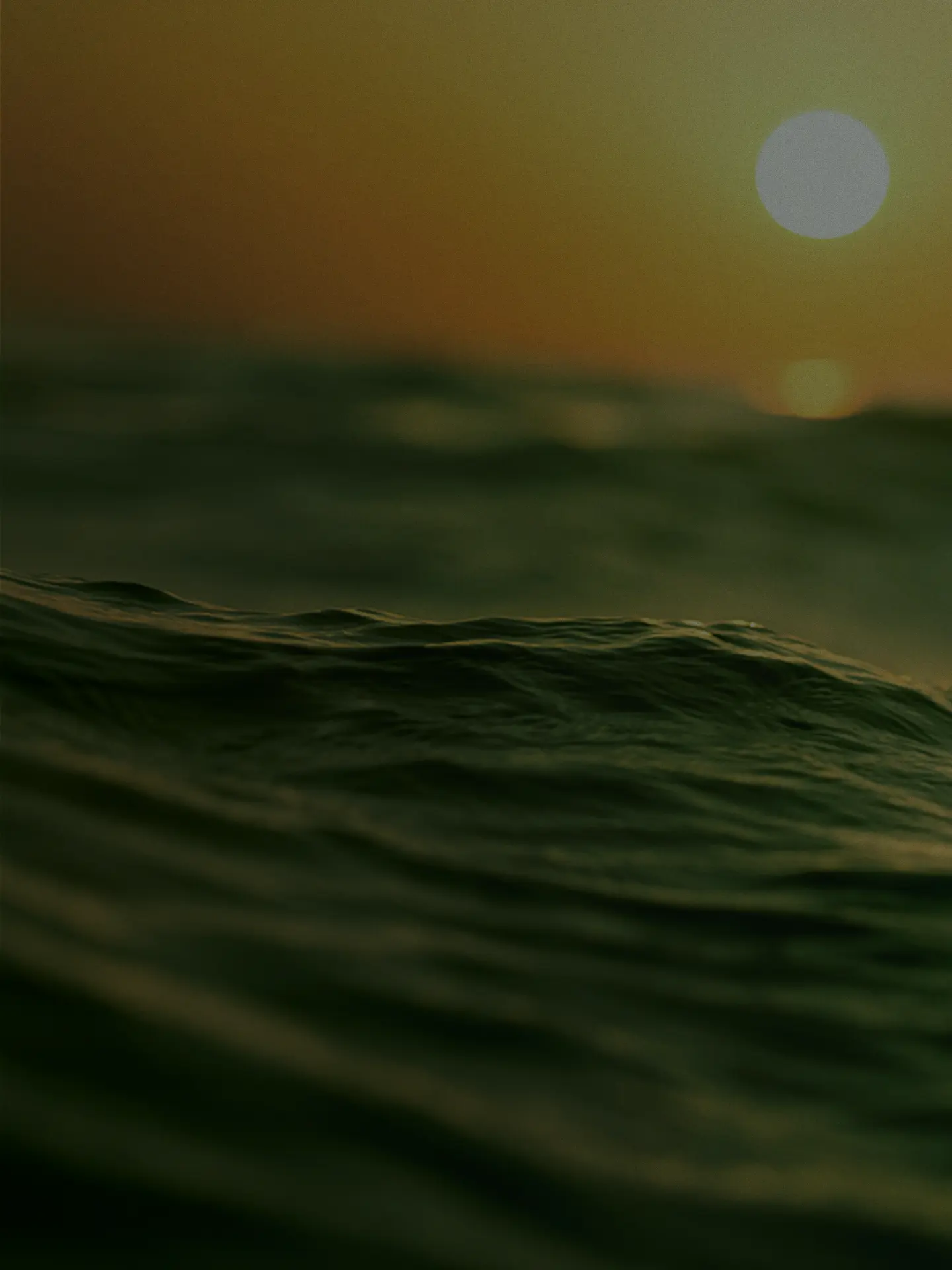 Close view of dark ocean waves at sunset
