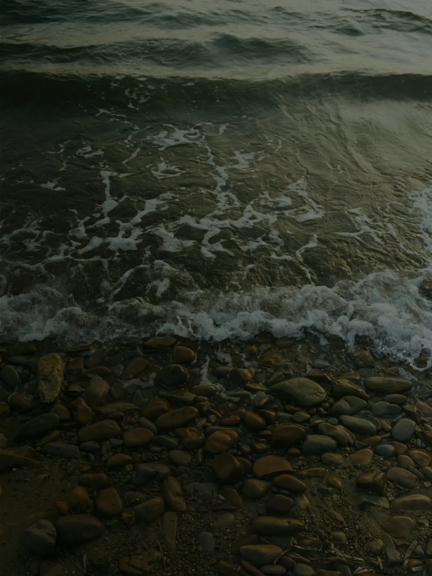 Ocean waves washing over a pebble shoreline